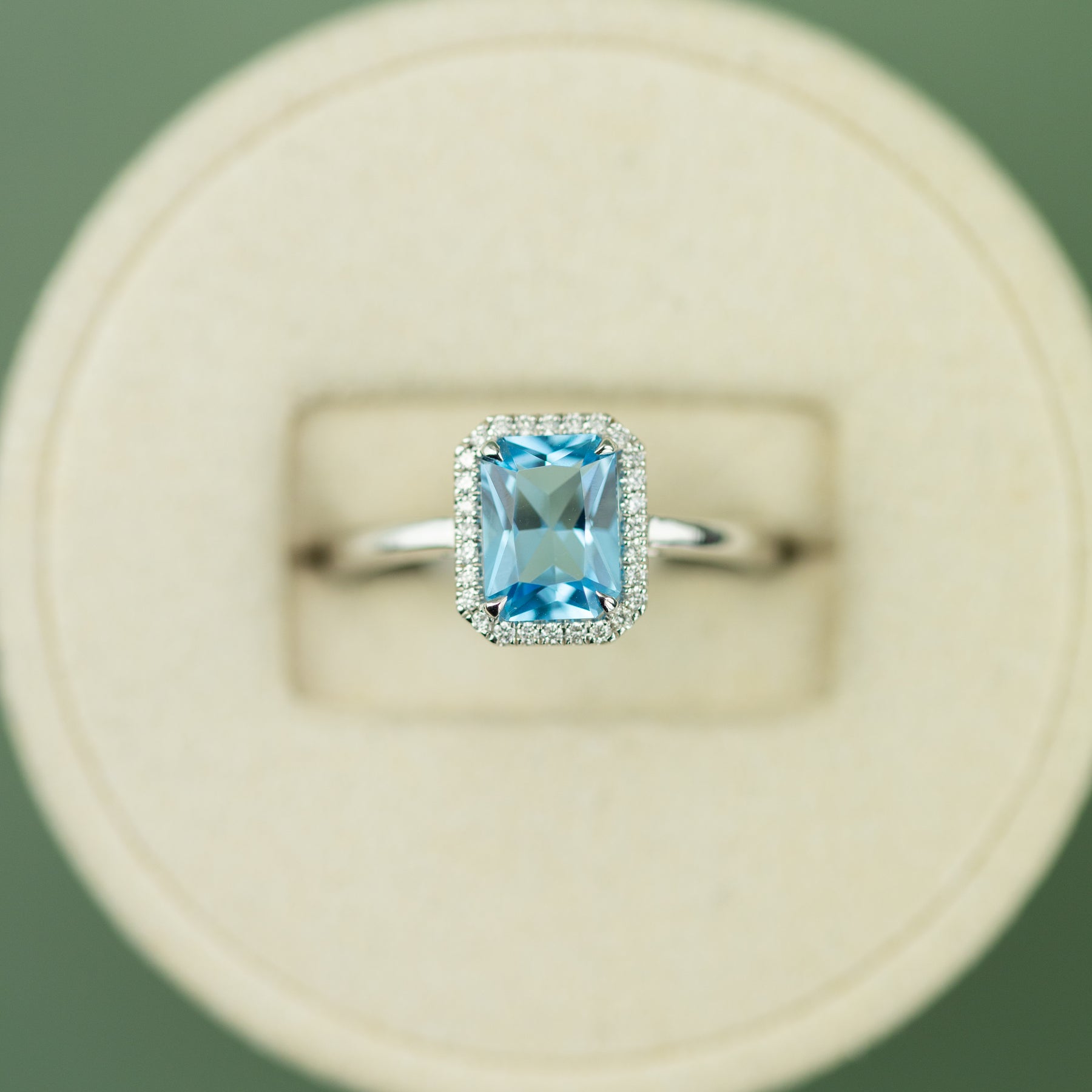 18 Karat White Gold Blue Topaz Emerald Cut Halo Ring 1.49ct