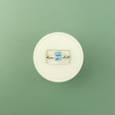 18 Karat White Gold Blue Topaz Emerald Cut Halo Ring 1.49ct