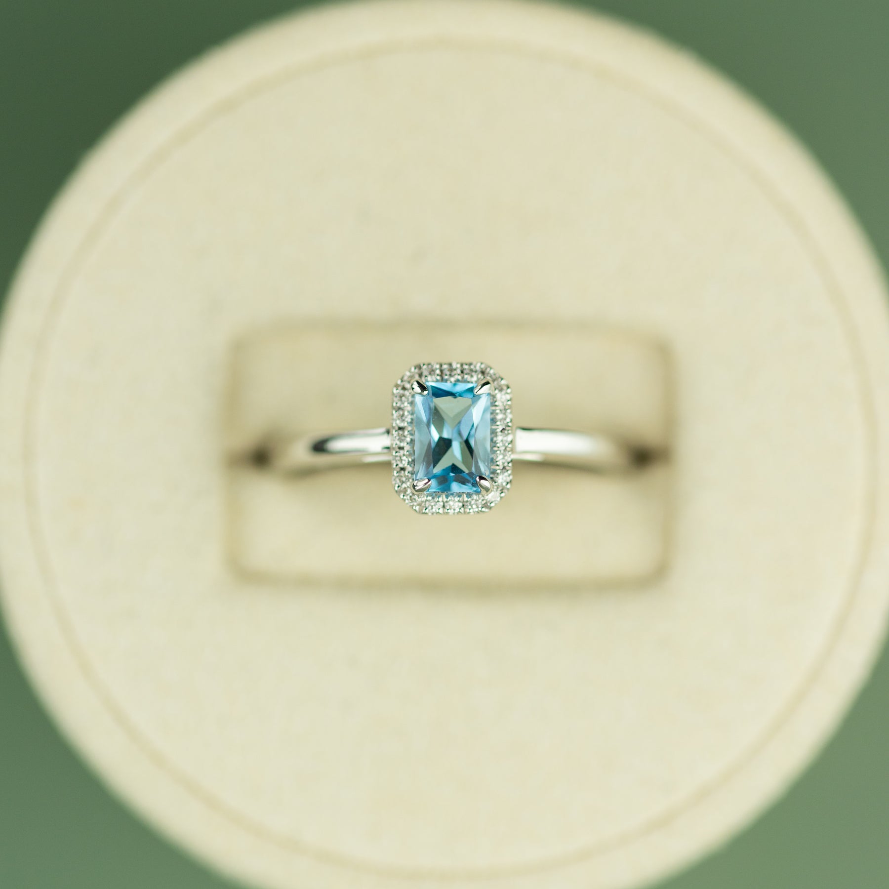 18 Karat White Gold Blue Topaz Emerald Cut Halo Ring