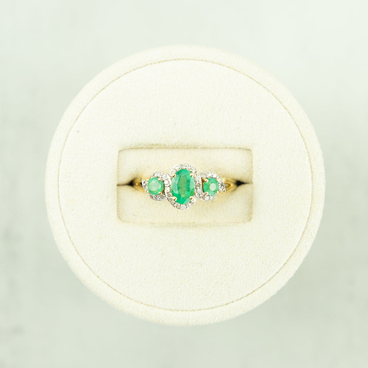 14 Karat Yellow Gold Emerald Trilogy Ring with Diamond Halo at RR Jewellers Yarm UK